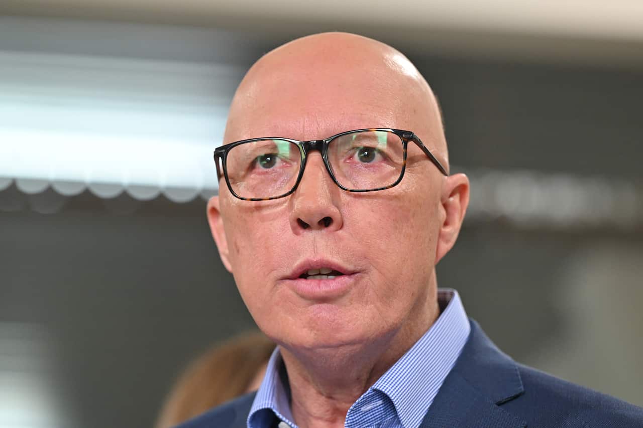 A man wearing a blue blazer and blue shirt.