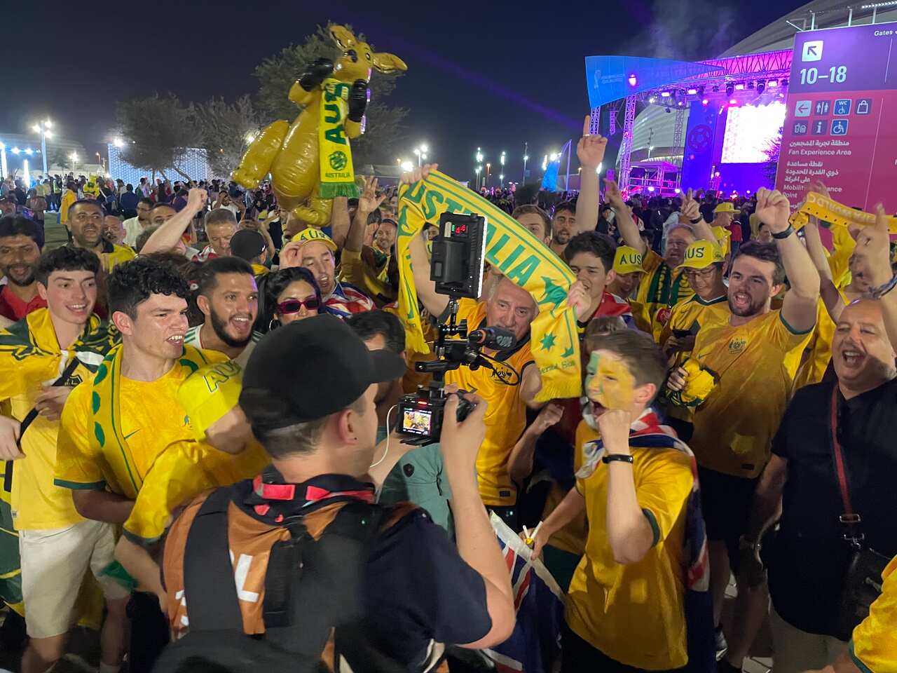 Socceroos fans in Qatar celebrate the performance of the Australian team. 