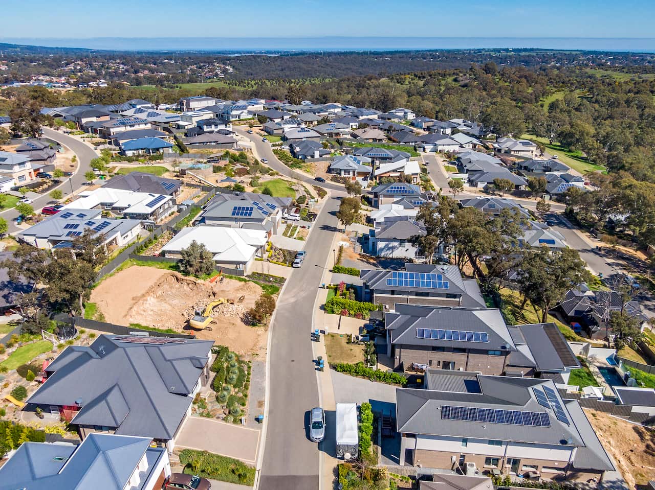 Large modern houses with grey roofs seen from above in a new suburb of Adelaide.