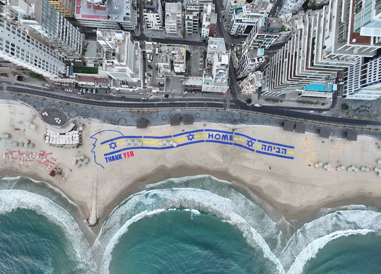 A silhouette of Donald Trump's head and the words 'thank you' on a beach