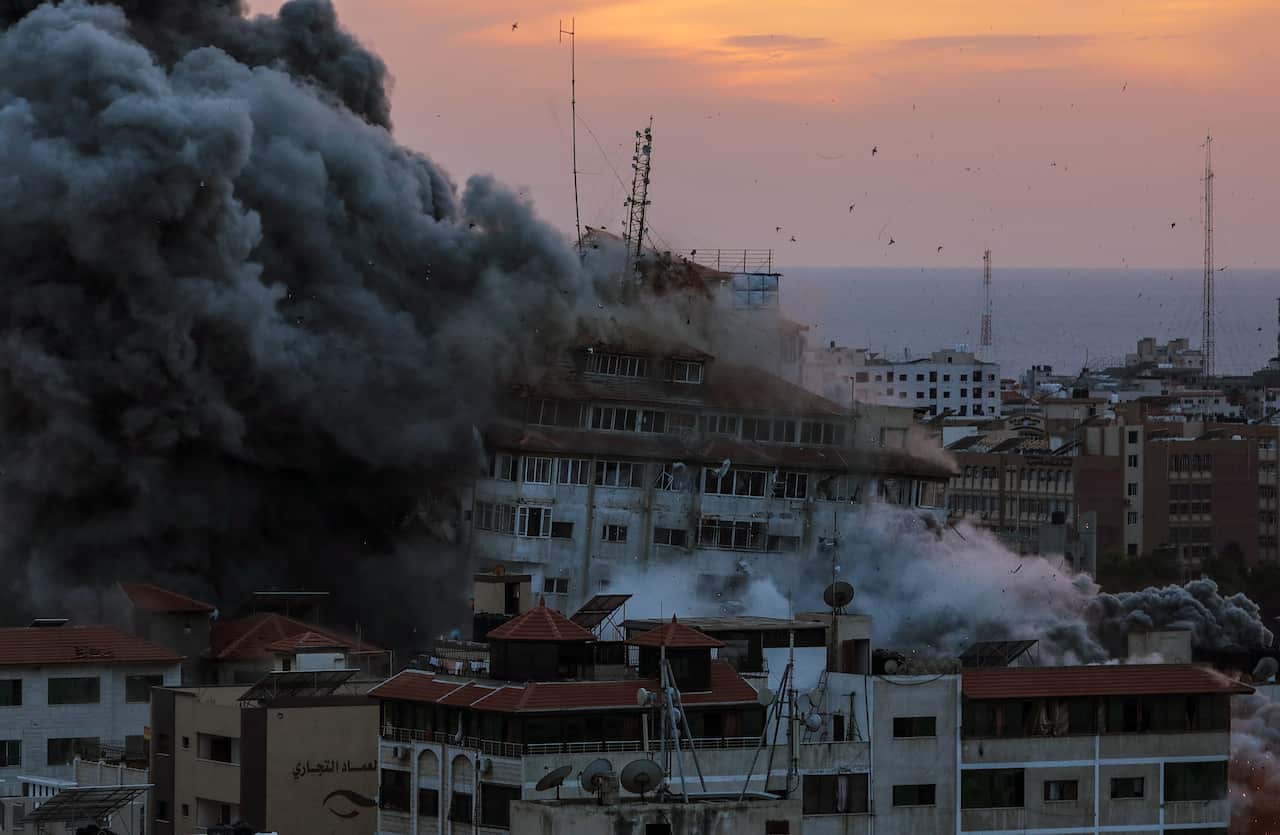 Thick plumes of smoke rises from buildings hit by air strikes.