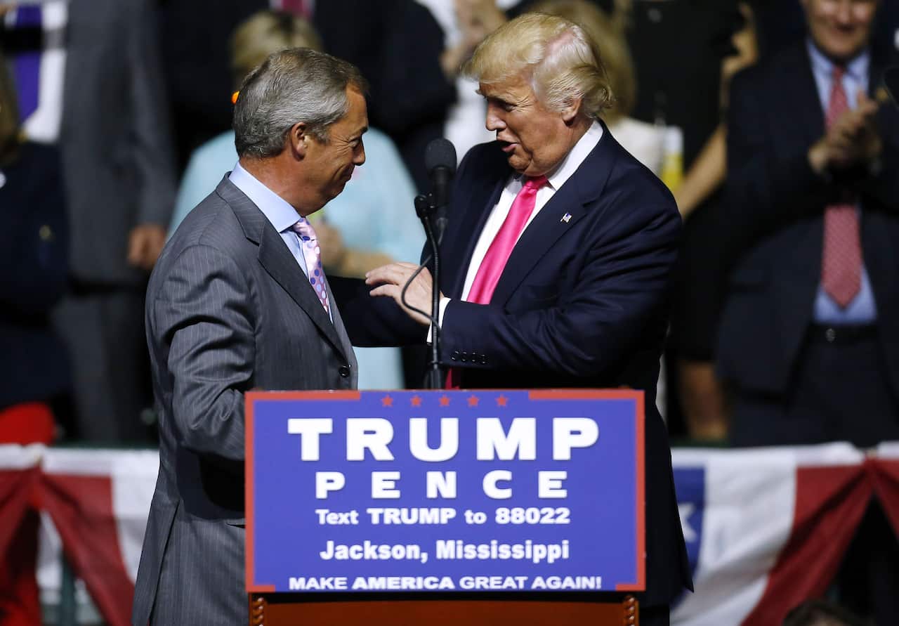 Donald Trump and Nigel Farage greet each other behind a podium with text reading "TRUMP PENCE". 