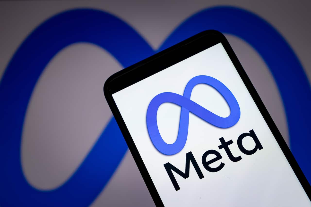 A phone screen displaying a blue logo and the words "Meta".