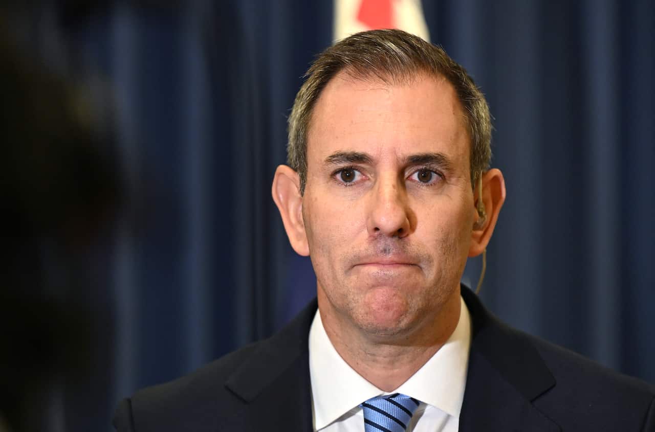 A middle-aged white man with short black and grey hair. He's frowning. 