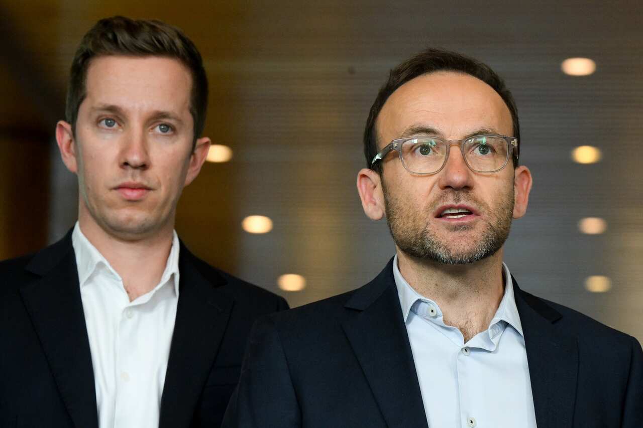 Two men in open necked shirts and jackets.