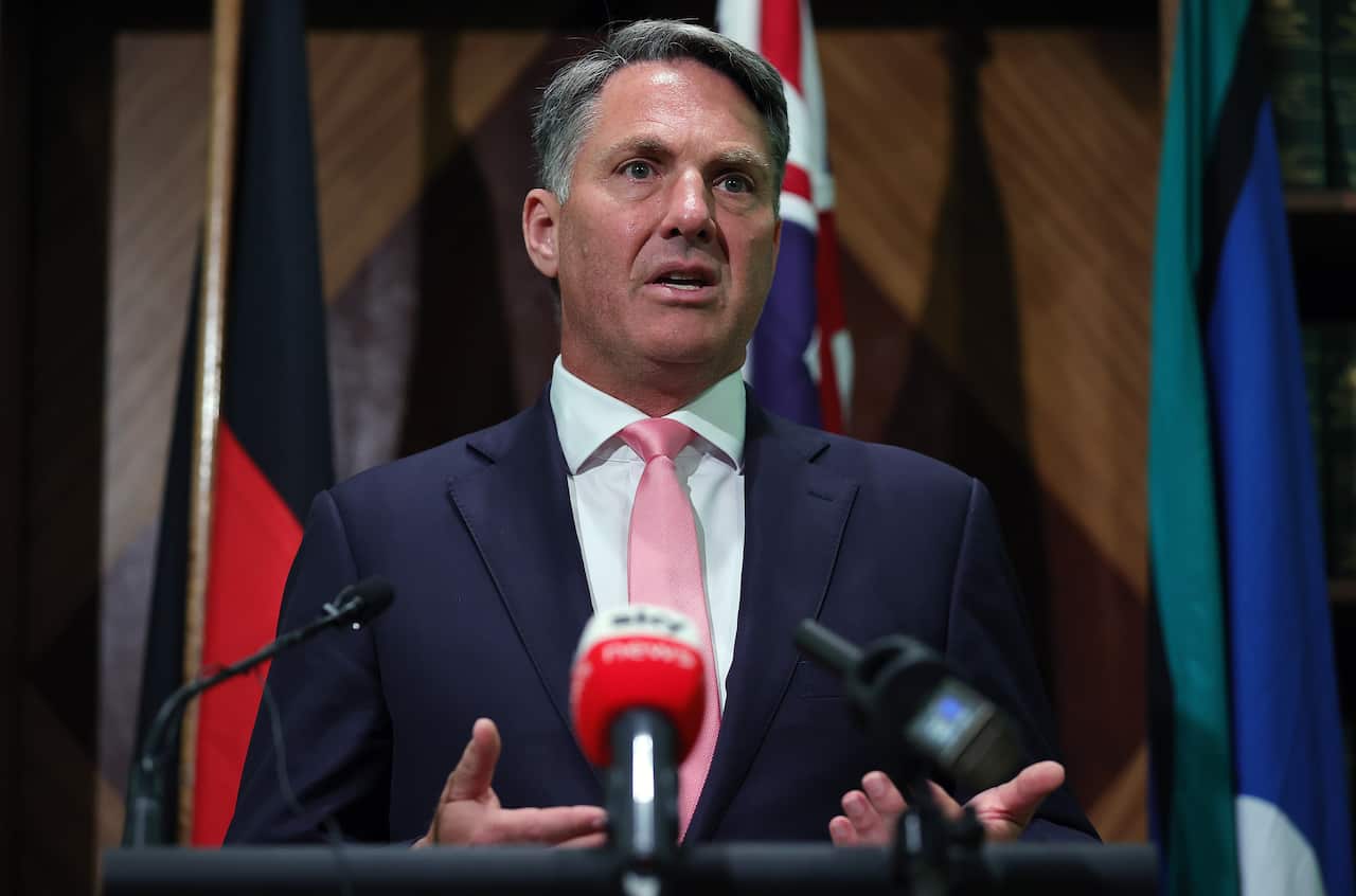 A man speaking at a microphone.