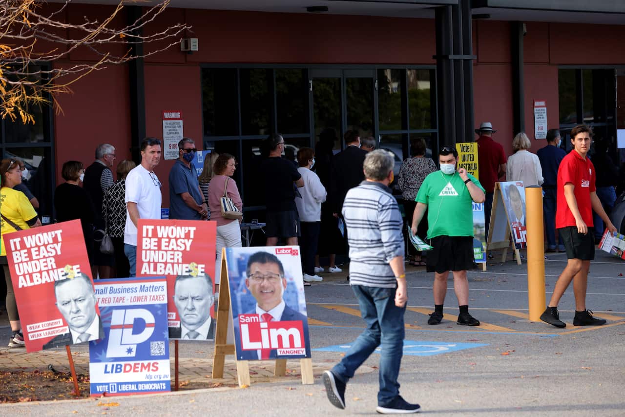 Political signs and people in a queue