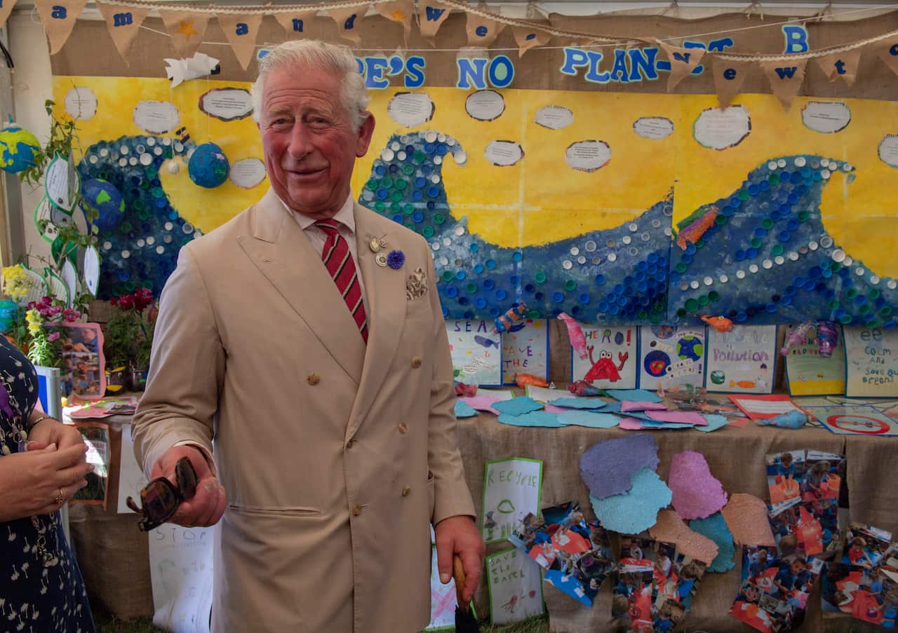 A man standing in front of a climate change exhibition