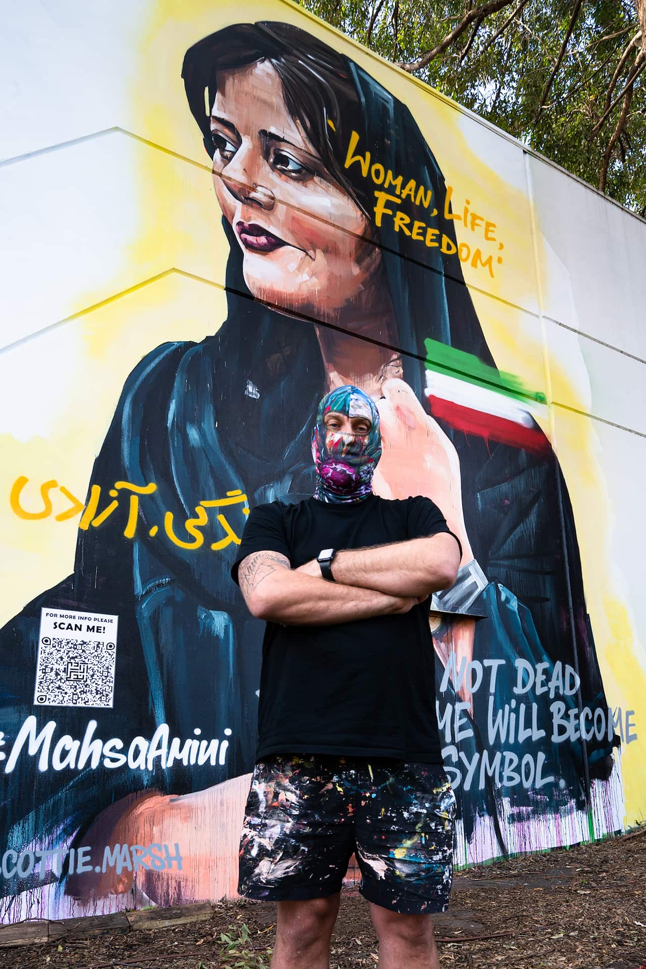 Artists Poses With Mural Of Masha Amini