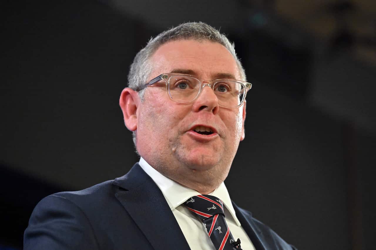 Man in glasses and suit.