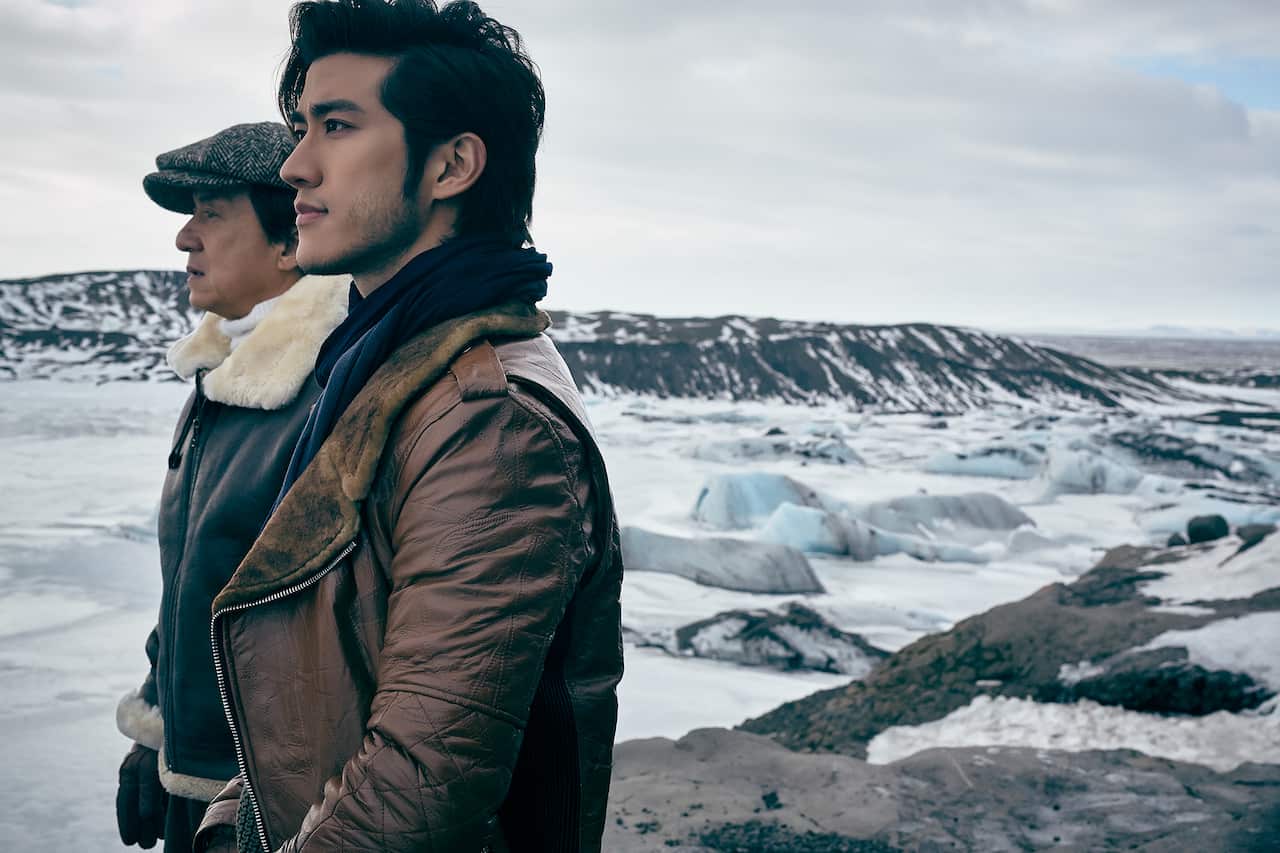 Two men stand in an icy landscape.