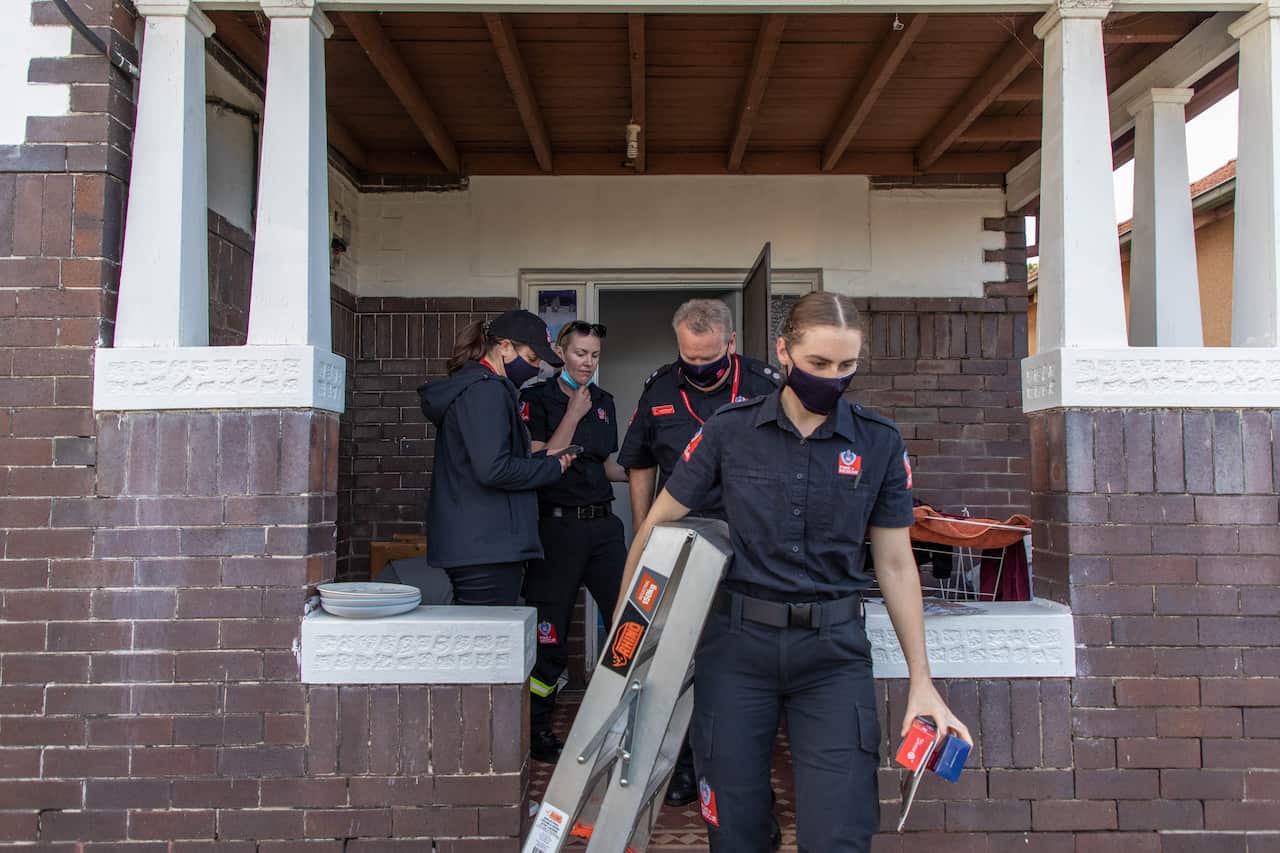 Firefighters leaving a house