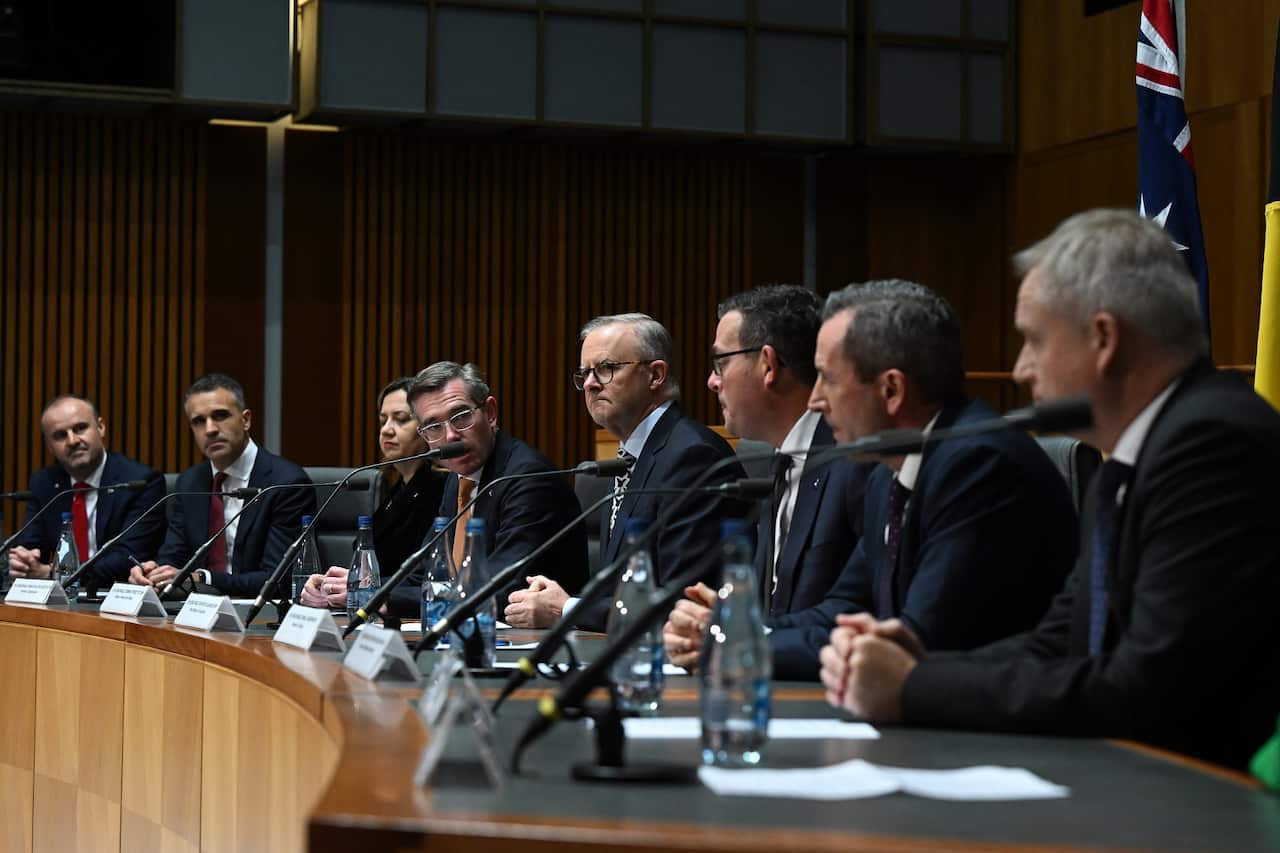 A group of politicians sitting at a national cabinet meeting.