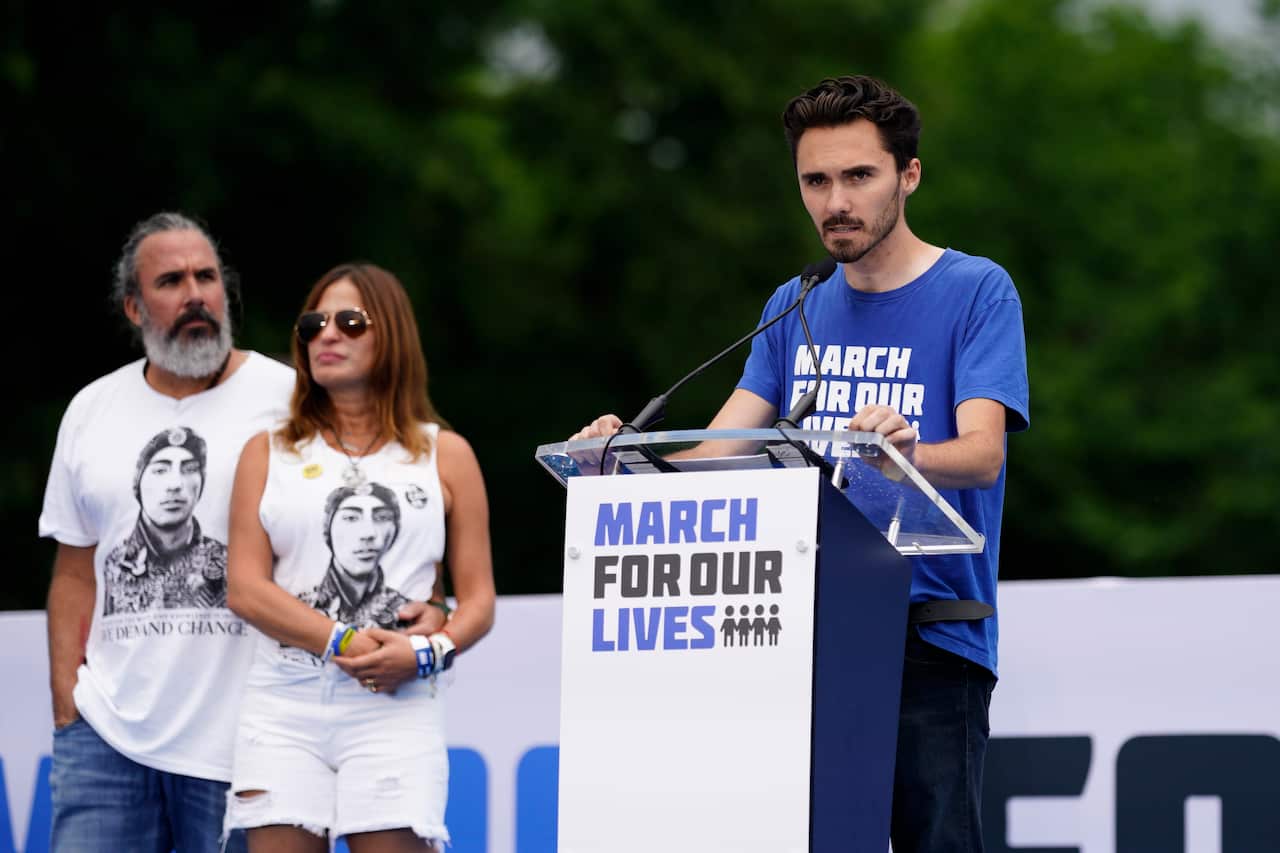 A man speaks at a podium.