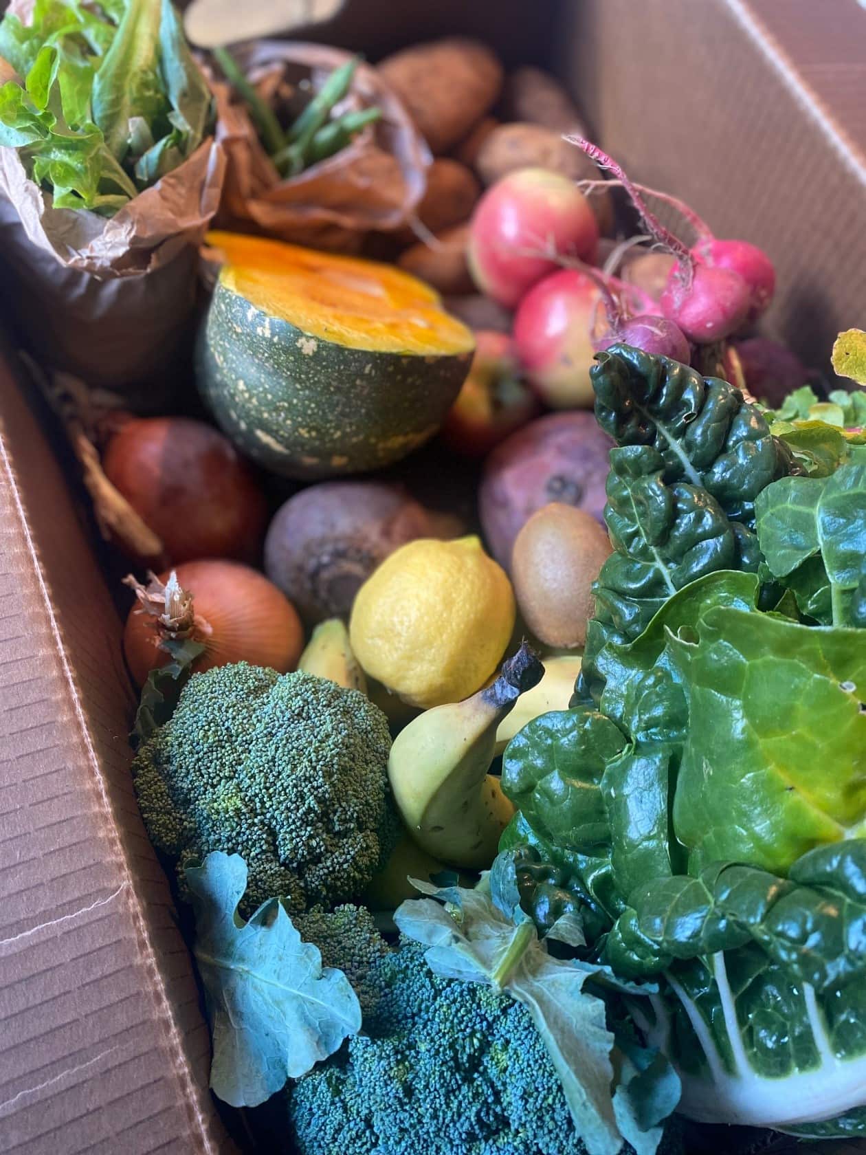  A vegetable box containing fresh produce from the farm.
