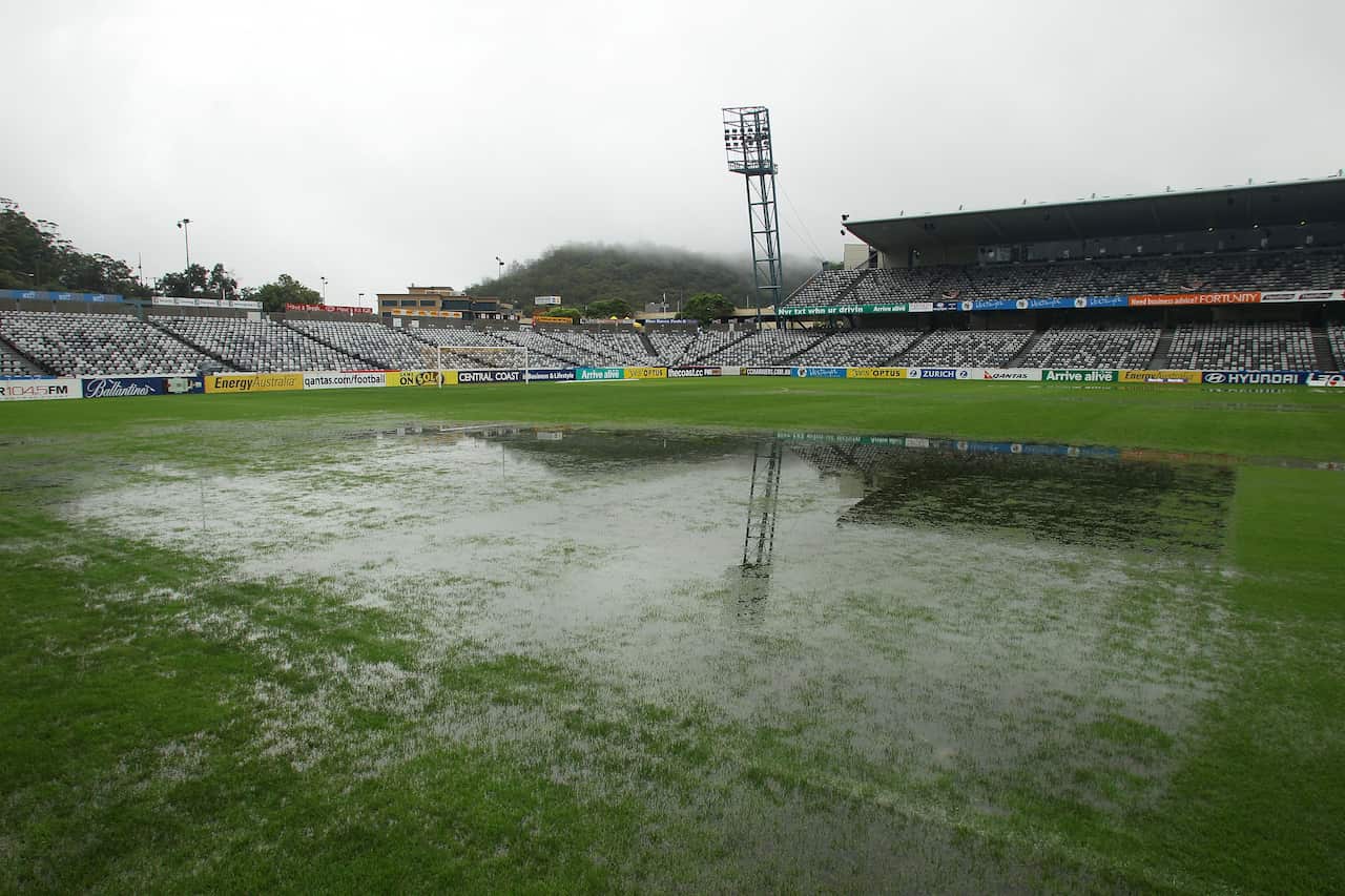 A general view of a flooded football field with an empty stadium