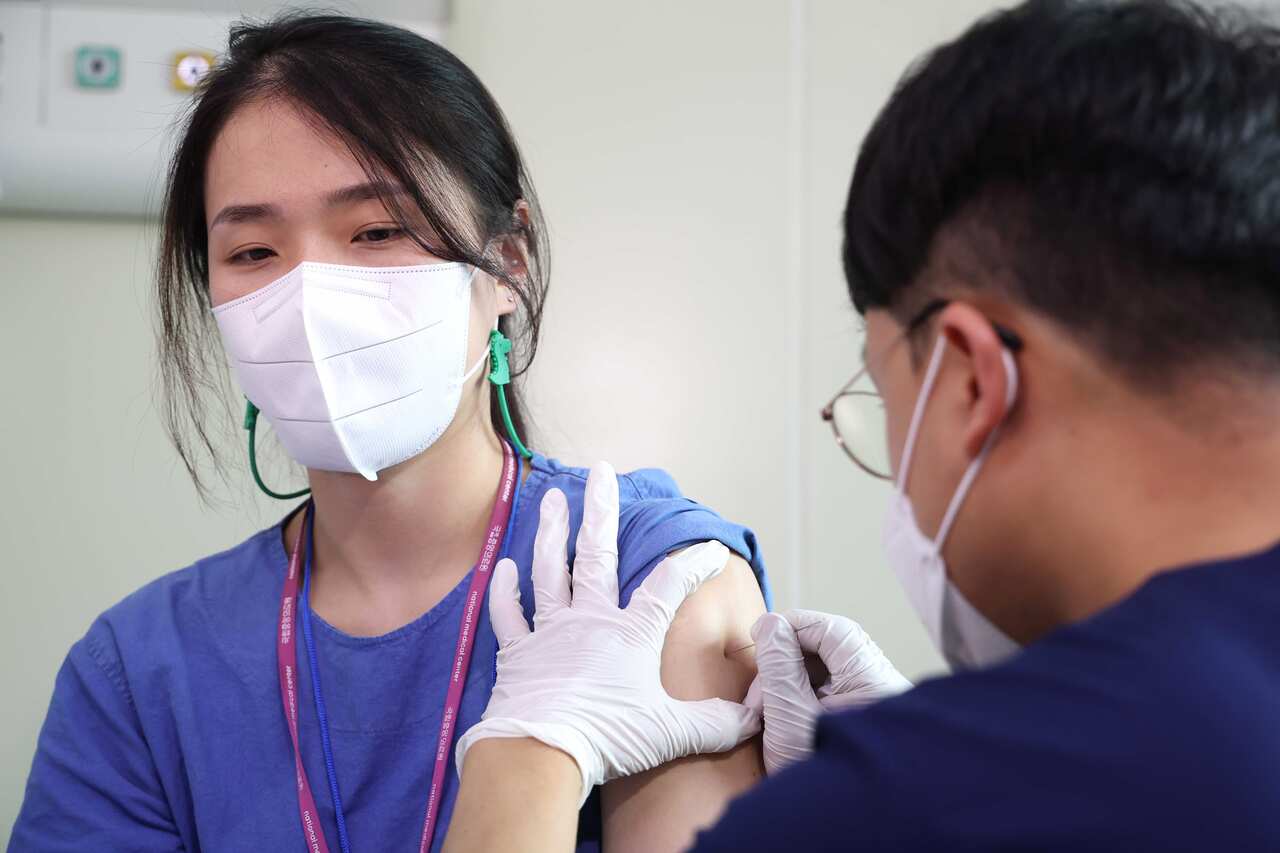 A medical worker gets a vaccine against monkeypox at the National Medical Center in Seoul, South Korea.