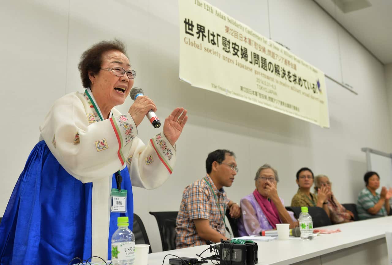 A woman speaks into a microphone.