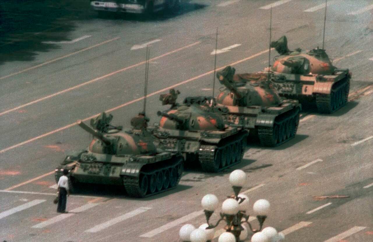 A Chinese man stands alone to block a line of tanks heading east on Beijing's Changan Boulevard in Tiananmen Square.