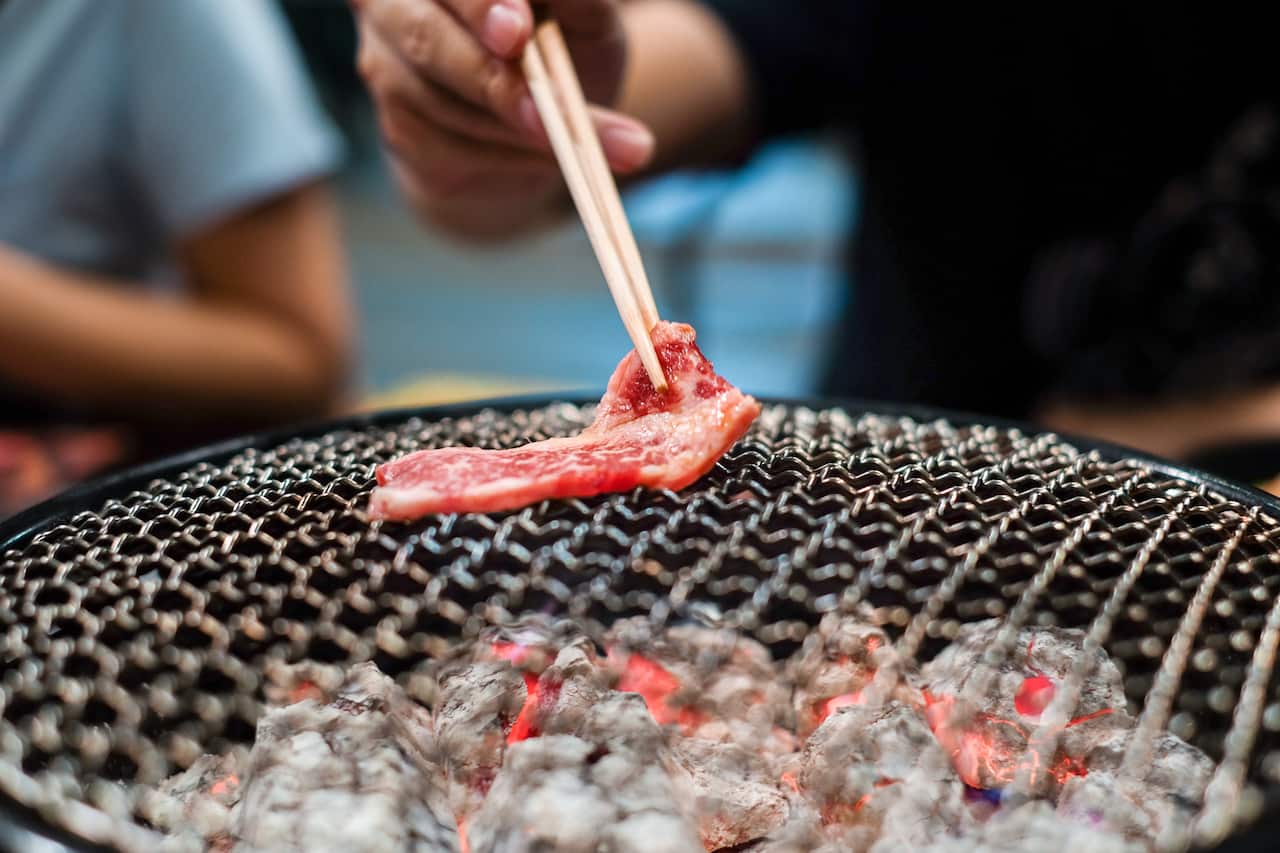 Grilling wagyu beef on charcoal grill
