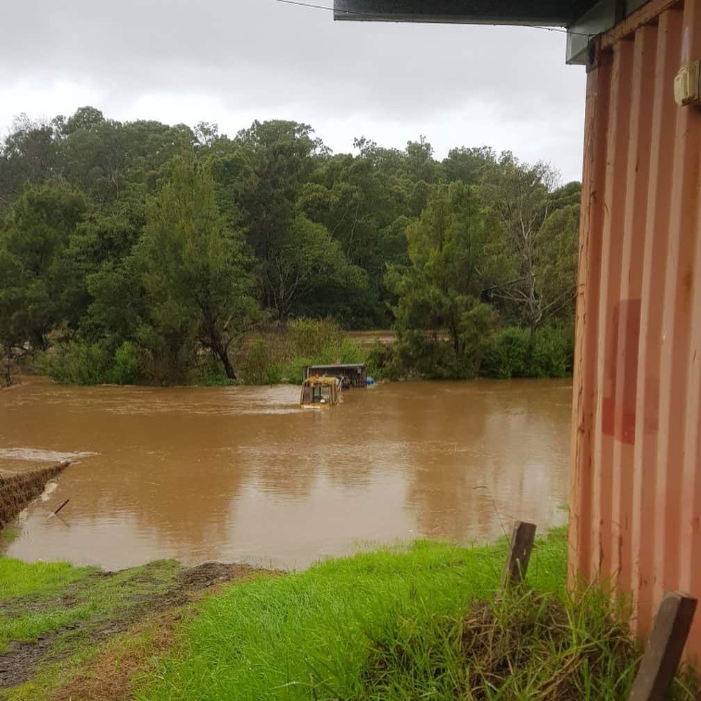 A rising river blocking access to a farm.