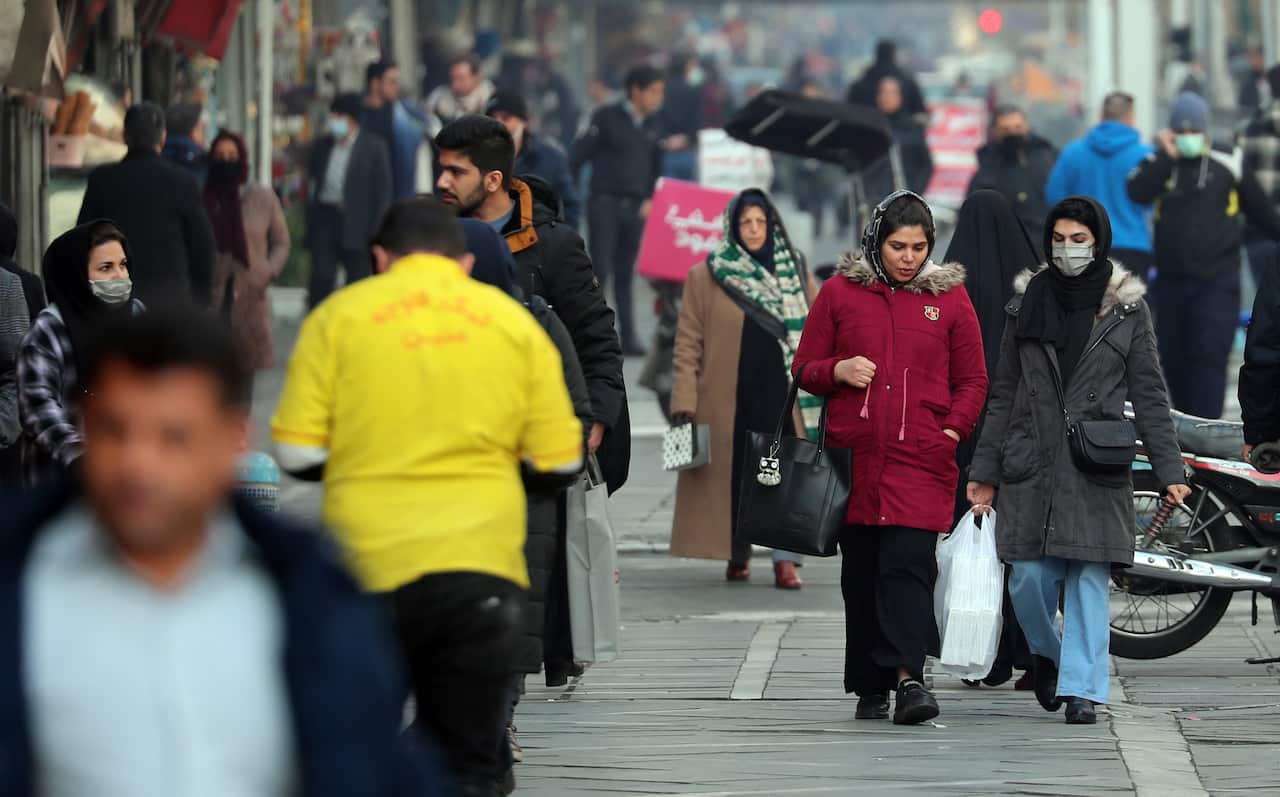 People walk in a street in a city