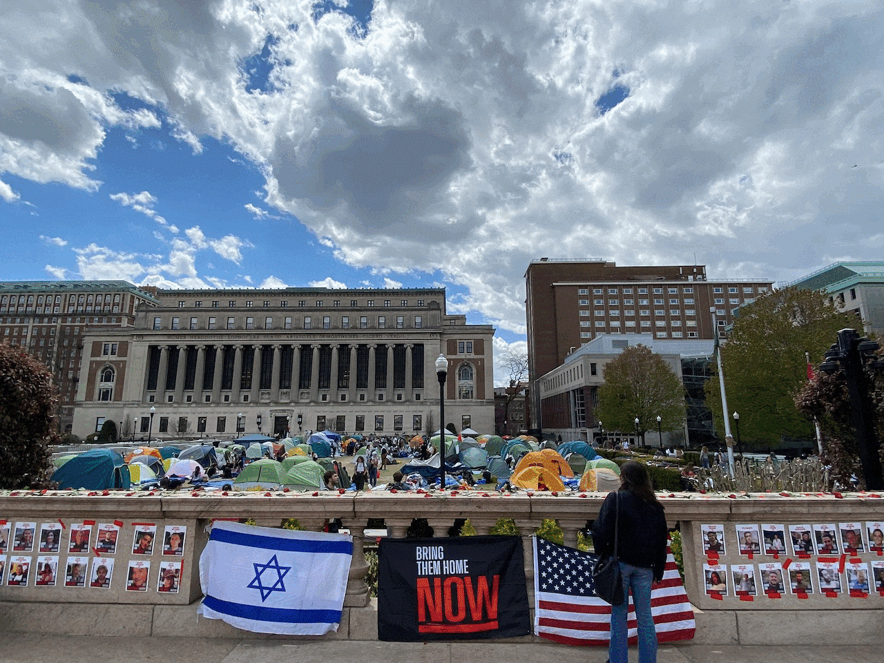 At Columbia University, students set up tents in protest on the front lawn. In another photograph, a US, Israel and 'Bring them home NOW'
flag adorns a bridge overlooking the pro-Palestinian protest. In the final image, a subway entrance has been spray painted with the text 'FREE PALESTINE'. The entrance is roped off with police tape.