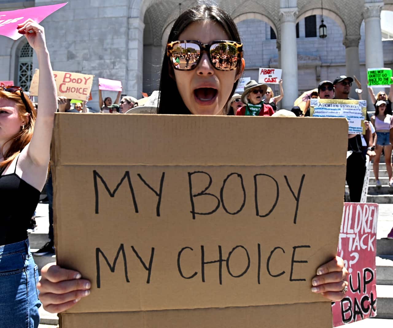Activists rally in front of City Hall in Los Angeles as they protest the Supreme Court's ruling on abortion.