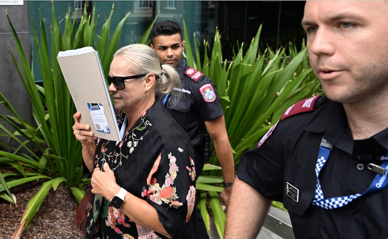 Witness, Watch House officer Debra Haigh (left) is seen leaving the Brisbane Coroners Court, in Brisbane, Wednesday, March 8, 2023. The Coroners Court is holding a joint inquest for two Indigenous women who died in custody. 