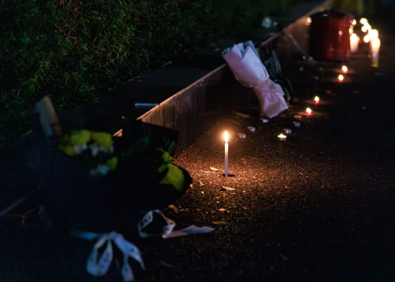 A single candle burns on the street in Zhuhai, in China's Guangdong