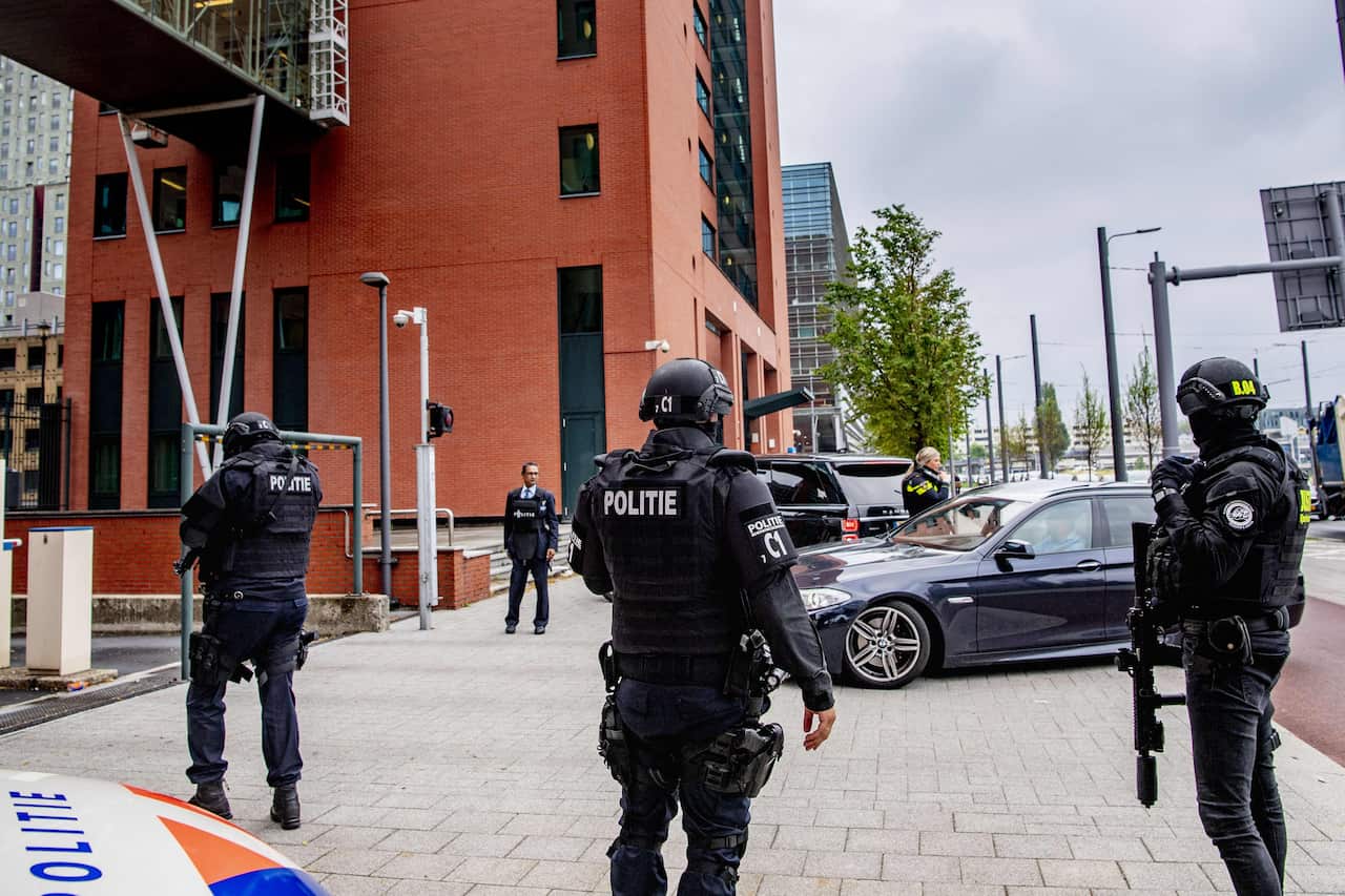 Armed police officers standing outside a court.