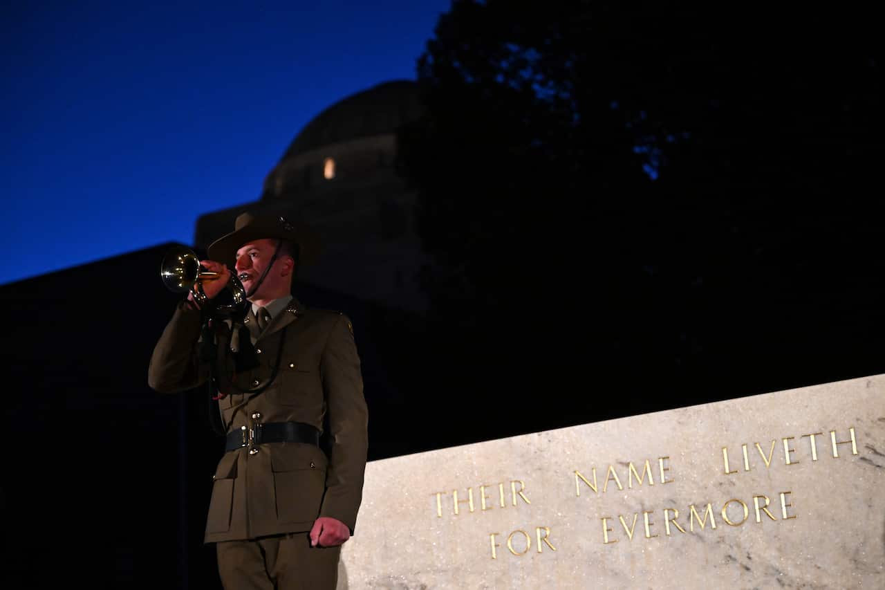 A member of the Australian Defence Force plays the last post near the Stone of Remembrance during the dawn service.