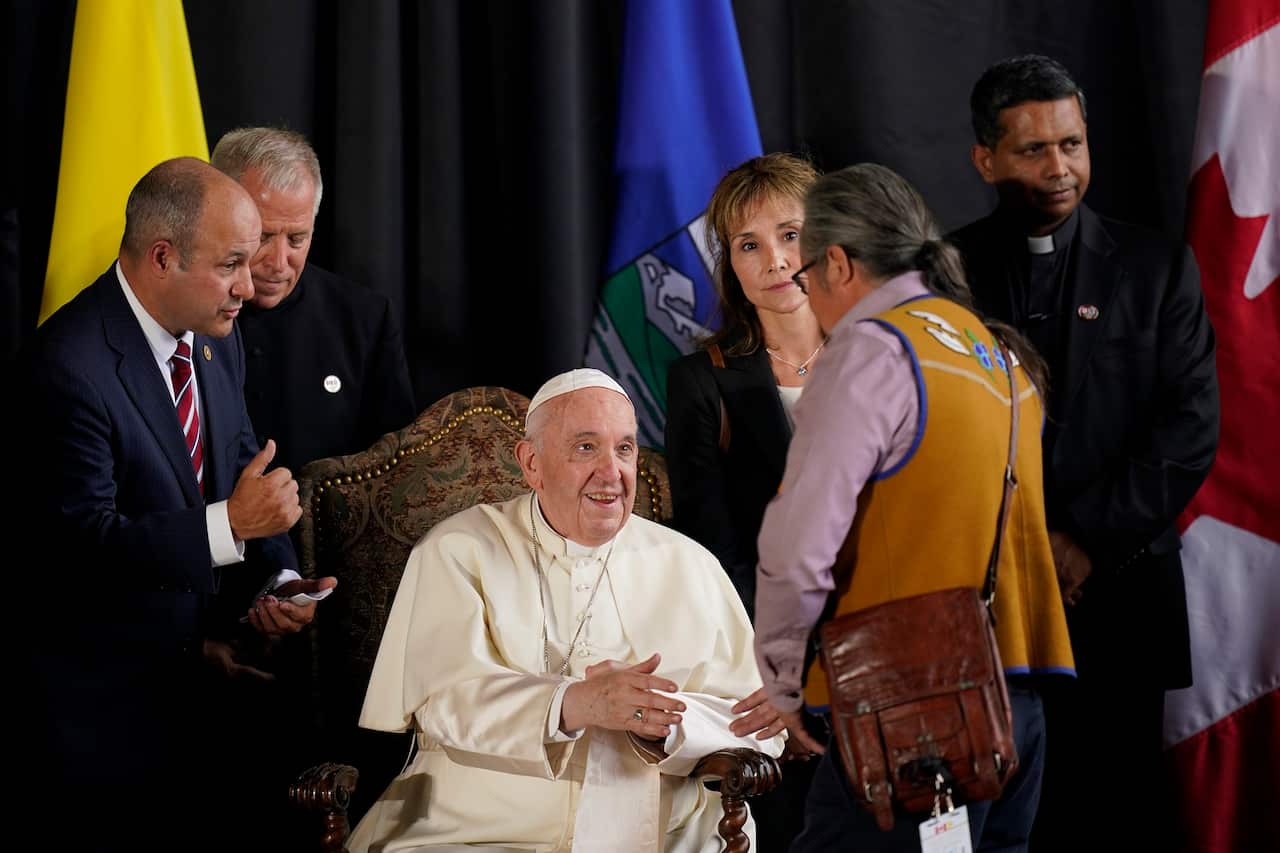 Pope Francis is welcomed by a group of Indigenous leaders Sunday, July 24, 2022, in Edmonton, Alberta, Canada. 