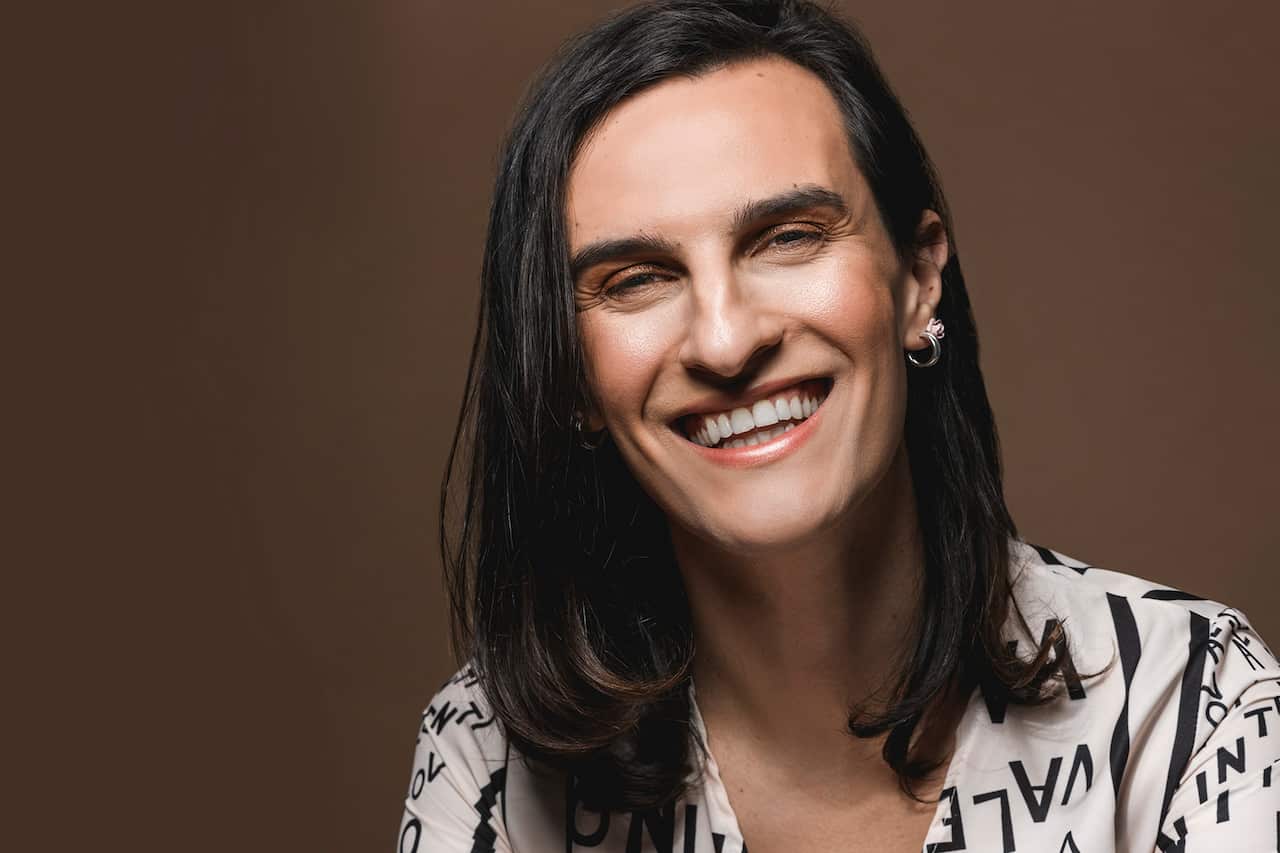 A trans woman smiling
