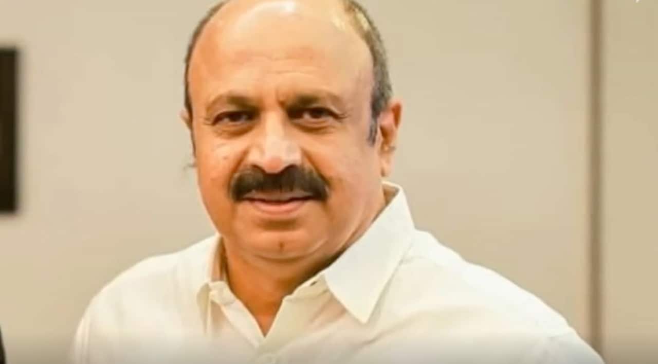 A picture of a middle-aged man with a moustache smiling lightly at the camera.