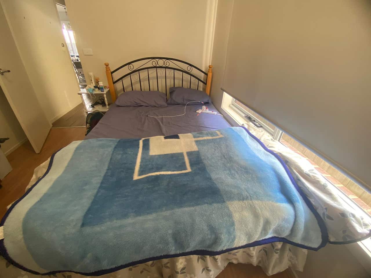 The bed Priyanka rents covered in a  blue blanket.