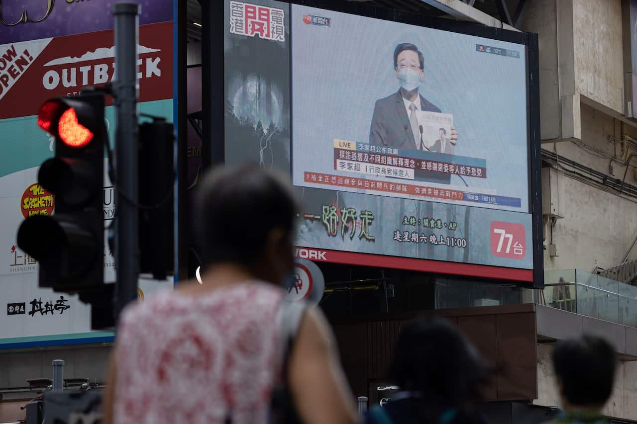 Former Hong Kong Chief Secretary John Lee Ka-chiu appears on a screen as he presents his Chief Executive election manifesto in Hong Kong, China, 29 April 2022.