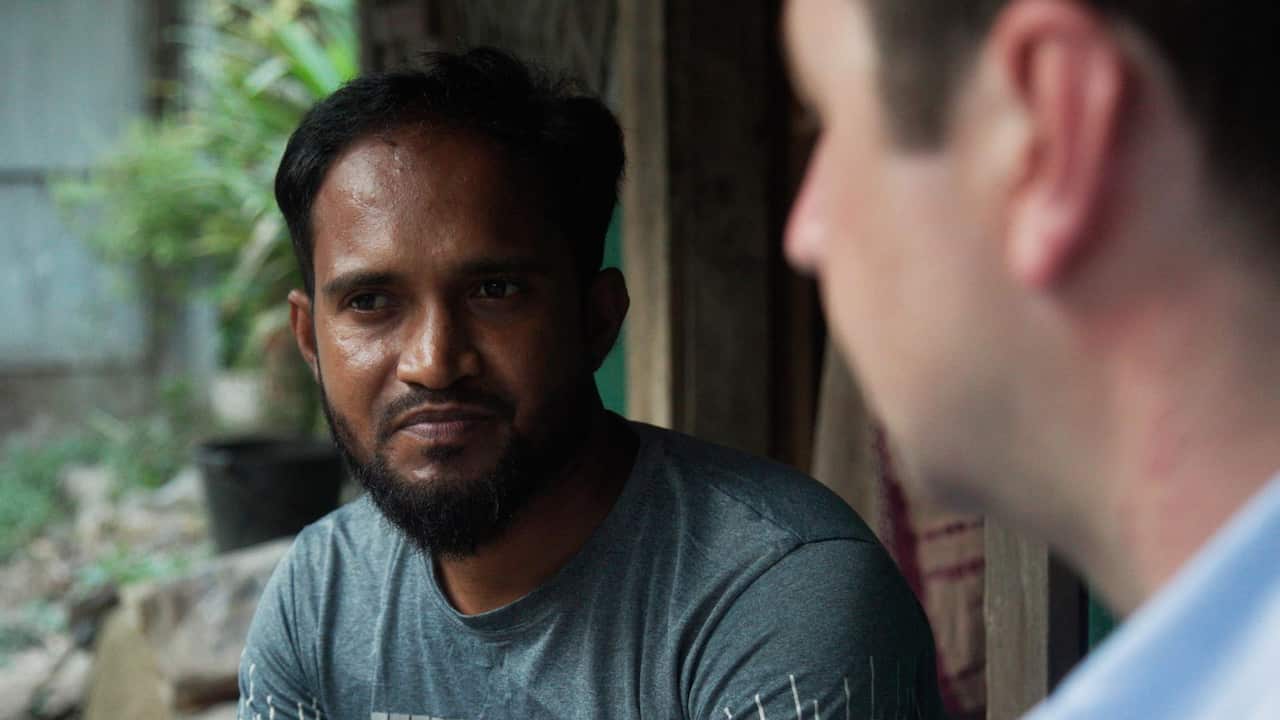 A man with beard and wearing a dark green t-shirt