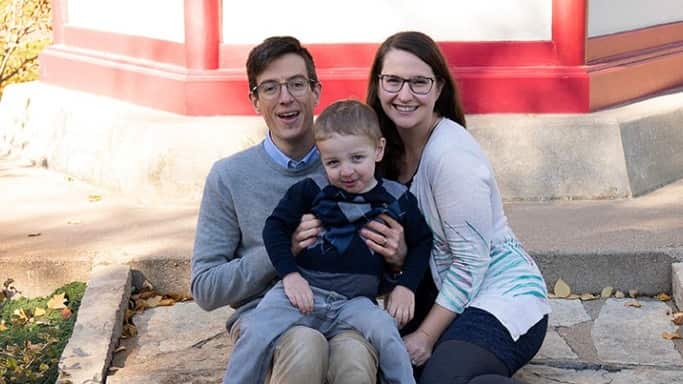 Man, woman, and young boy sitting outside