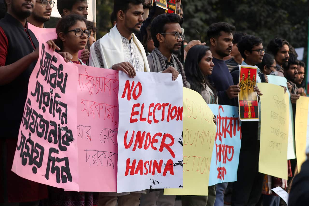 People hold placards during a protest.