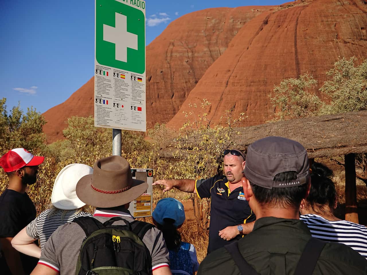 A tour guide walked through the safety precautions of hiking into Kata Tjuta near a tent