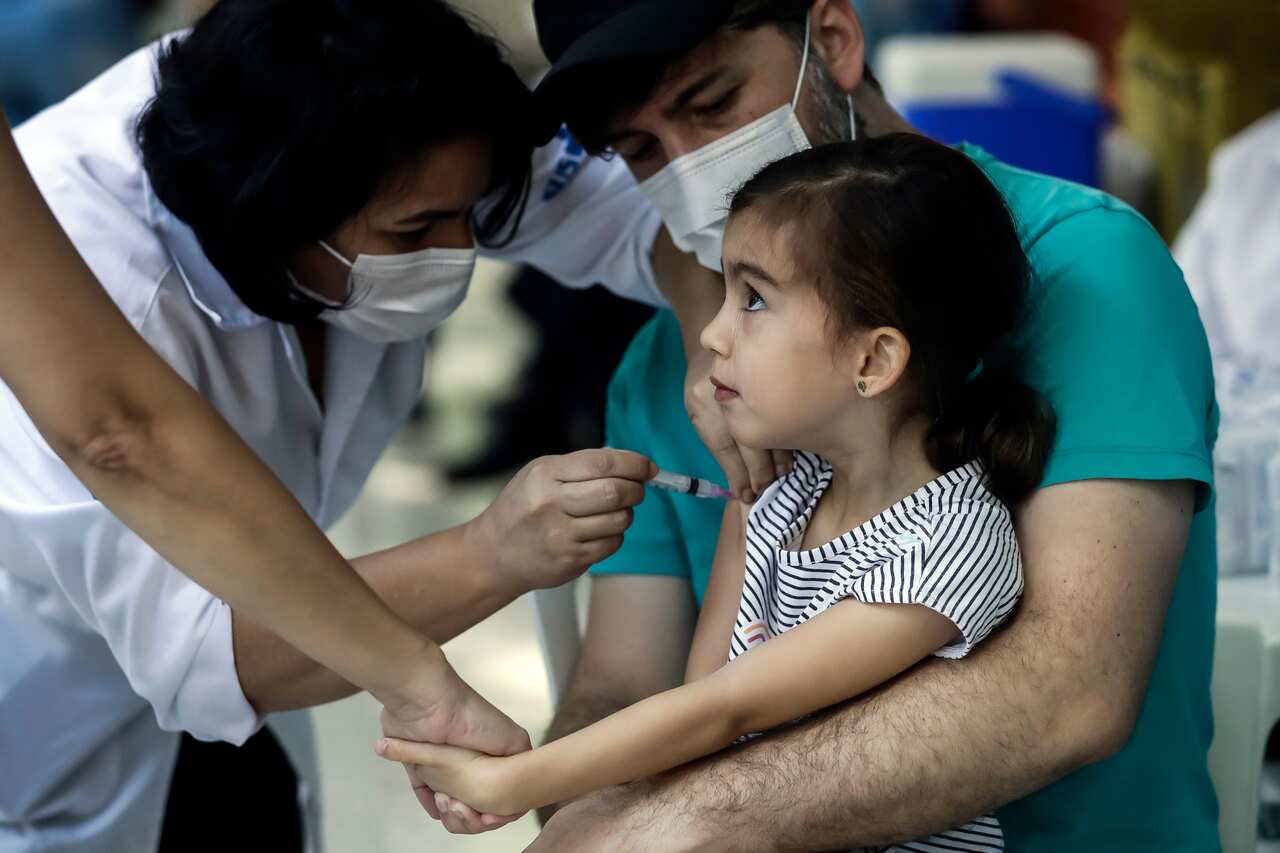 A girl gets a shot of the CoronaVac vaccine on the first day of a COVID-19 vaccination campaign for children ages 3 and 4 at a vaccination center in Rio de Janeiro, Brazil.