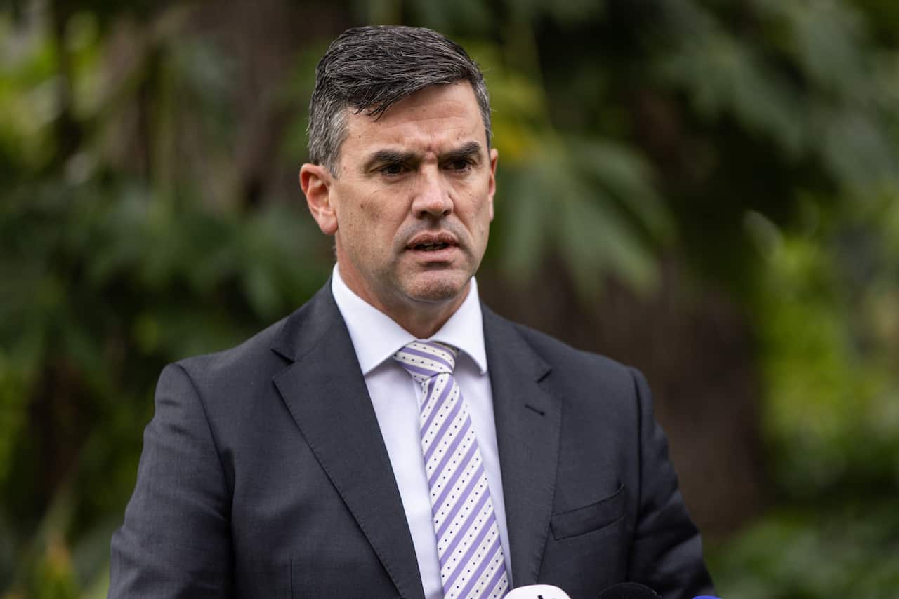 Wearing a dark suit, Victorian Opposition leader Brad Battin speaks to media during a press conference.