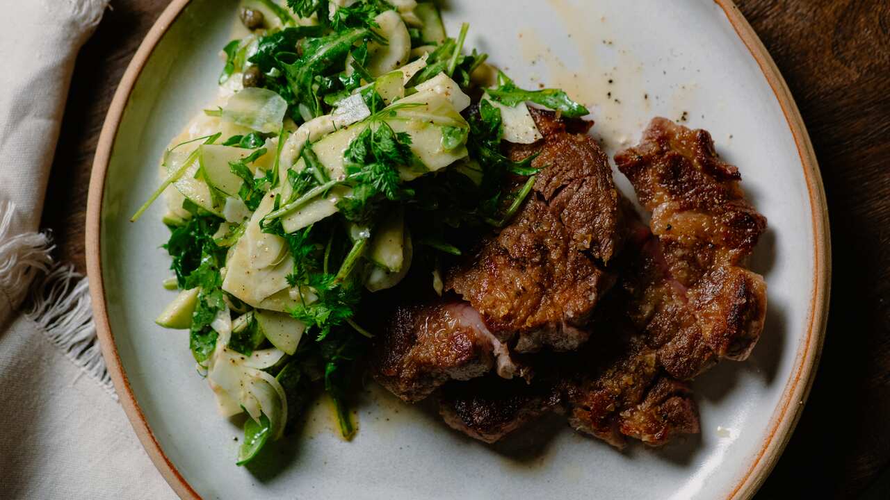 Pork neck steaks with rocket, fennel and apple salad