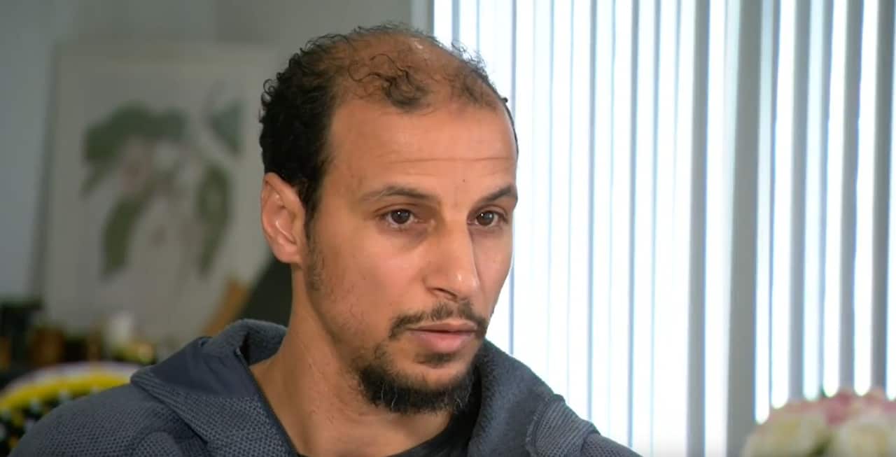 A man in a dark blue hoodie.