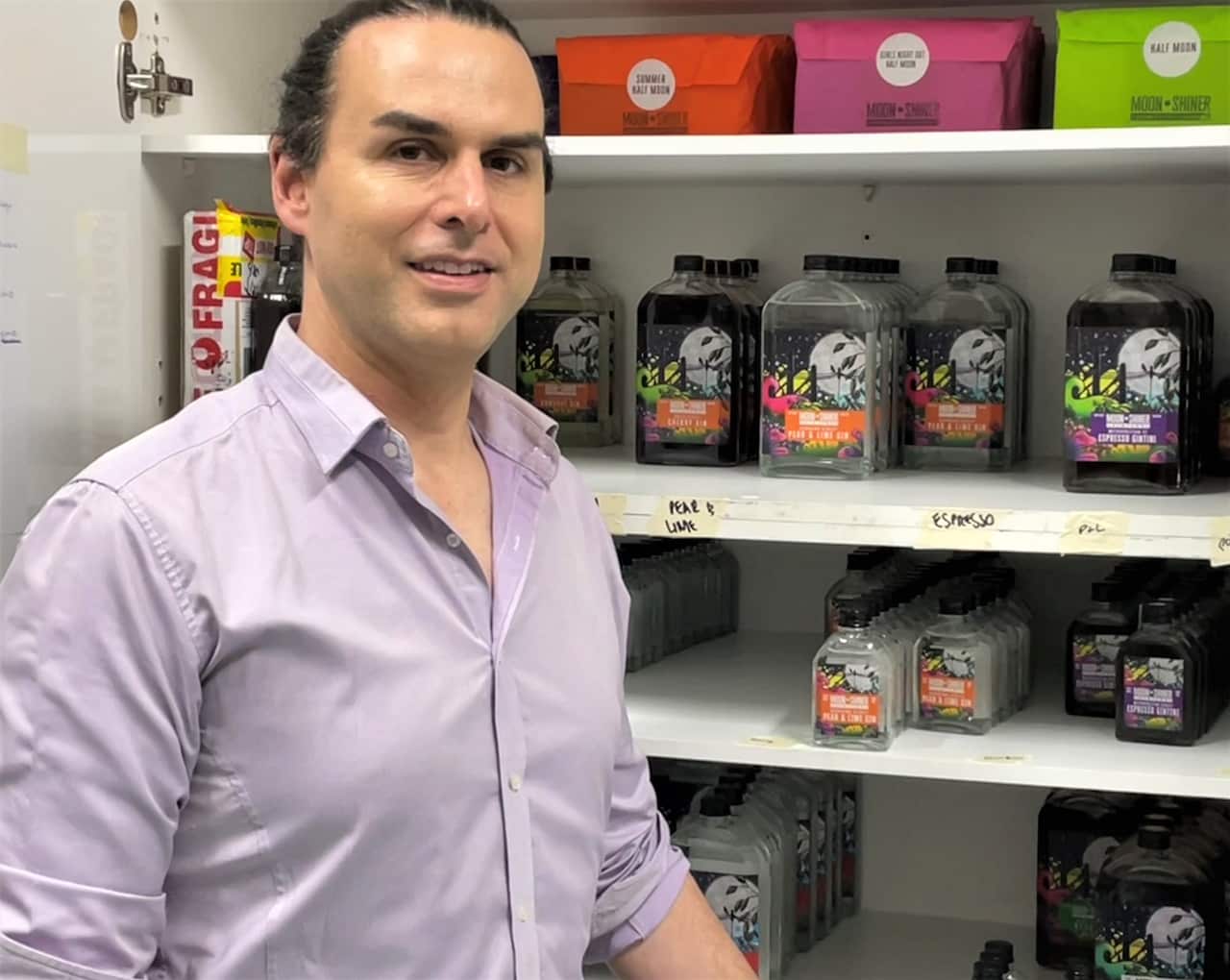 Andy Leonard in front of a cabinet of drinks