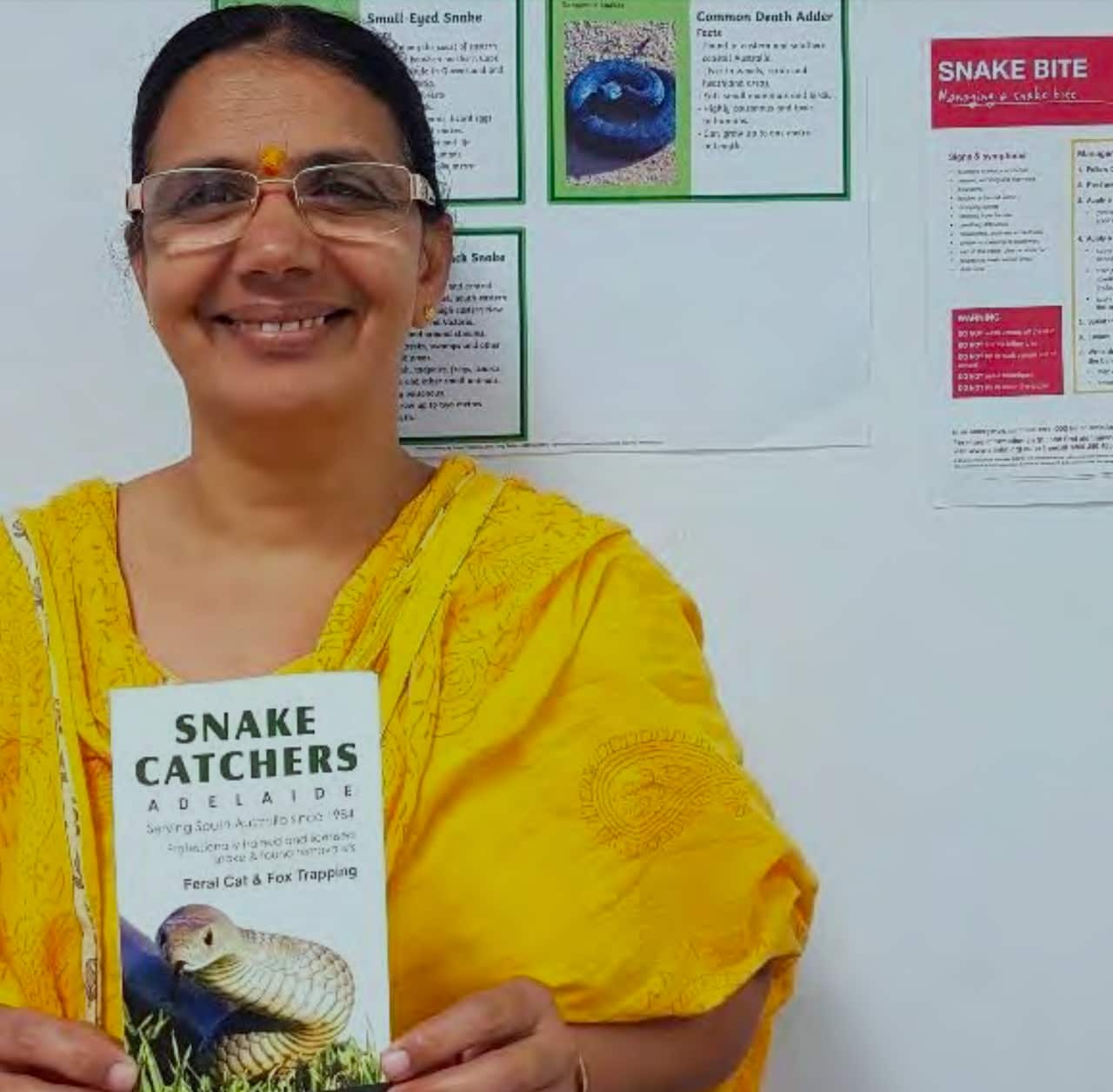 Woman holding snake catchers leaflet