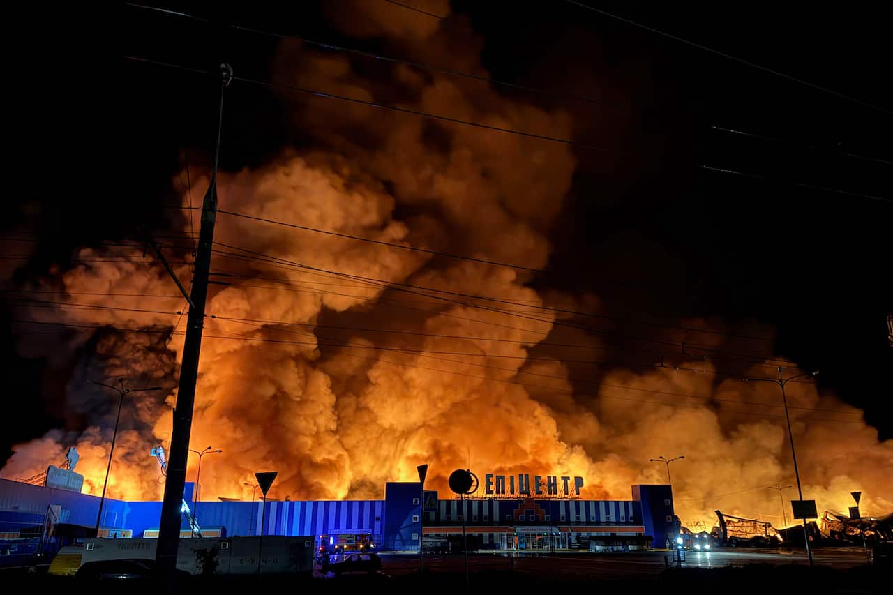 A large fire above a shopping centre.