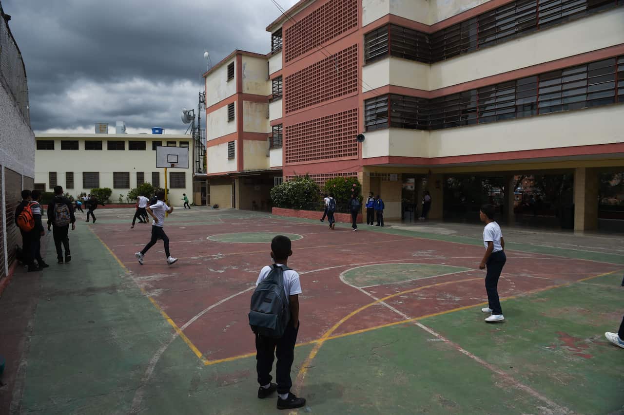 Children playing on a court at a school.