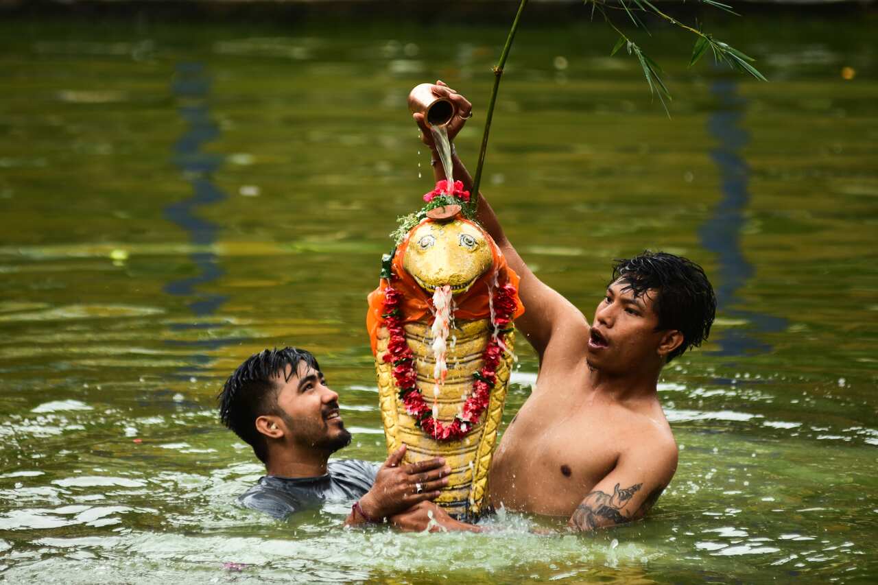 Devotees worship a statue of snake deity also known as 'Naga Dev' on the occasion of Nag Panchami at Bhaktapur, Nepal.